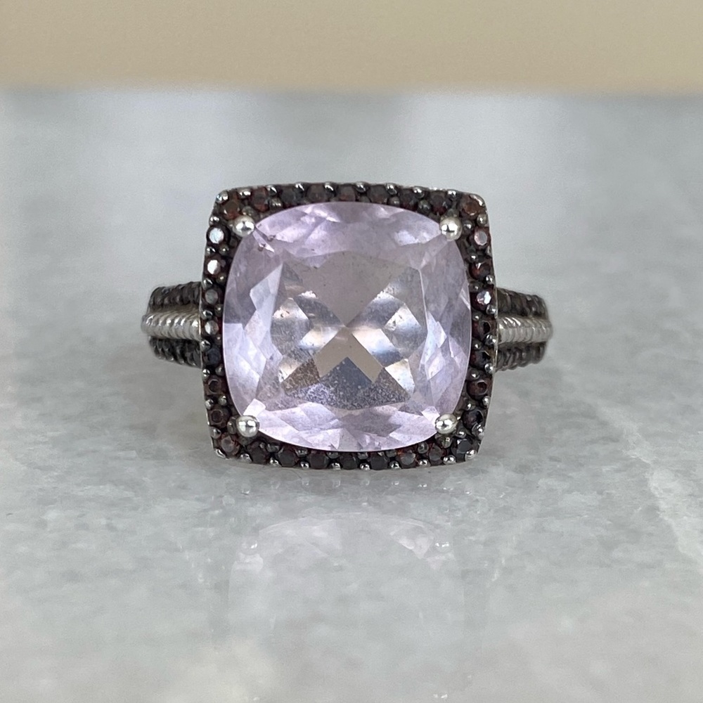 Amethyst ring with dark purple/black spinel stones surrounding center stone